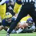 Michigan linebacker Desmond Morgan and Northwestern quarterback Kain Colter reach for a fumble in the second quarter at Michigan Stadium on Saturday. Melanie Maxwell I AnnArbor.com
